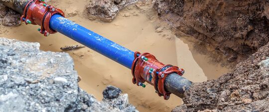 gritty water line open exposes pipe in mud