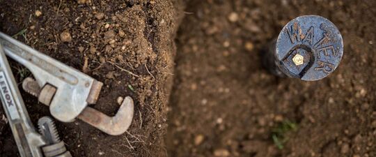 A pipe is on the ground and a water pipe is exposed
