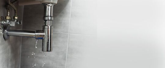 Underneath a leaking sink