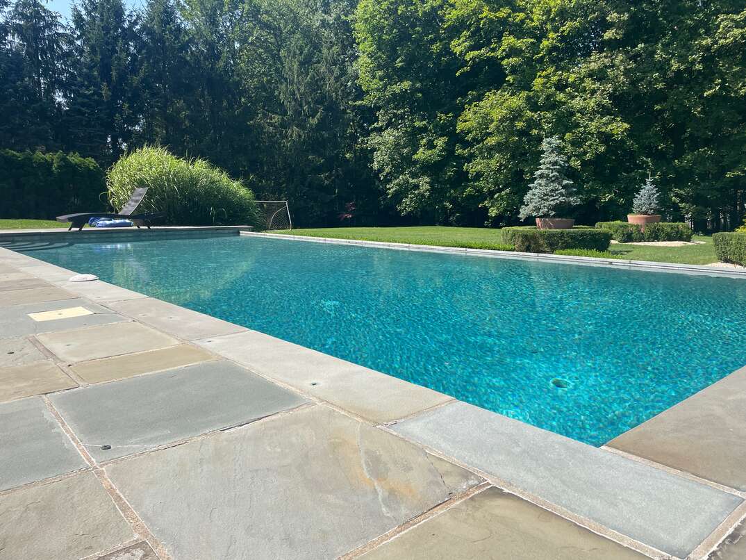outdoor inground pool surrounded by stone