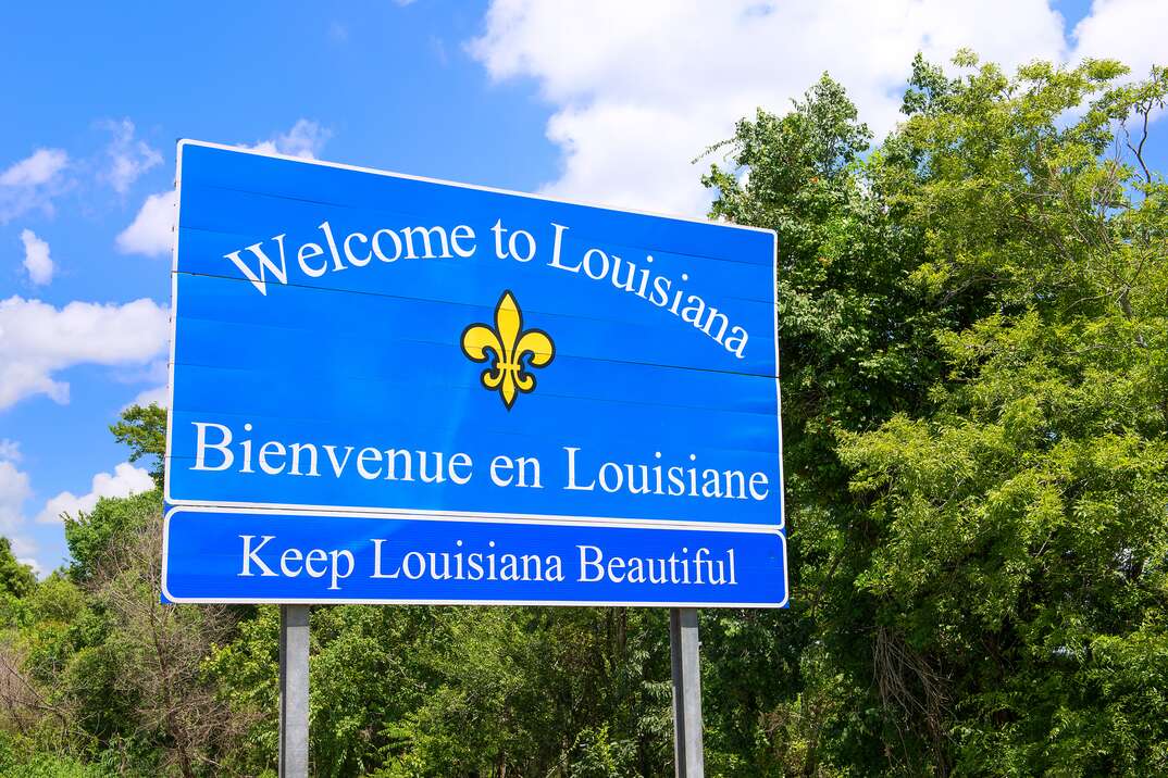 photo shows the  Welcome to Louisiana   Bienvenue en Louisiana  sign next to highway