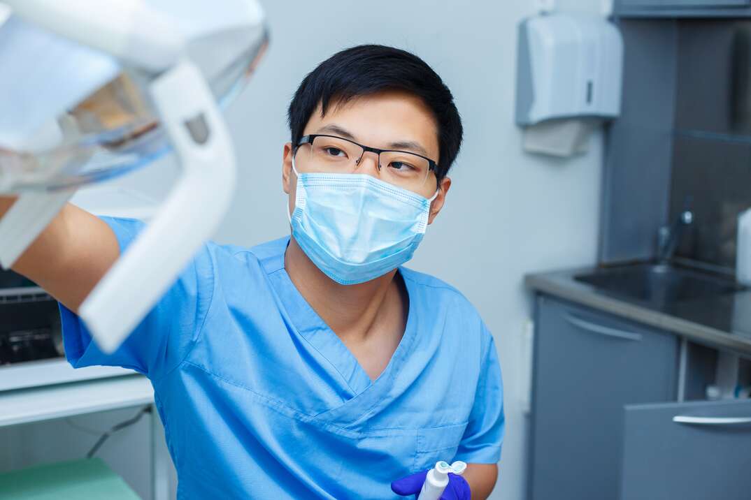 Dentist preparing his workplace in the dental office. Dentistry, medicine, medical equipment and stomatology concept