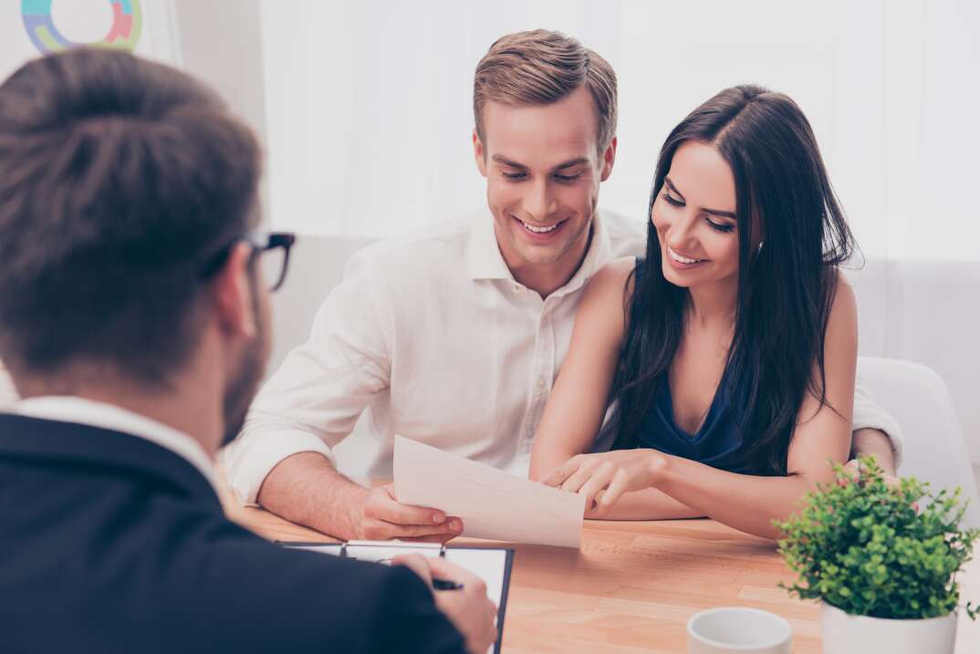 Successful lawyer giving consultation to family couple about buying house