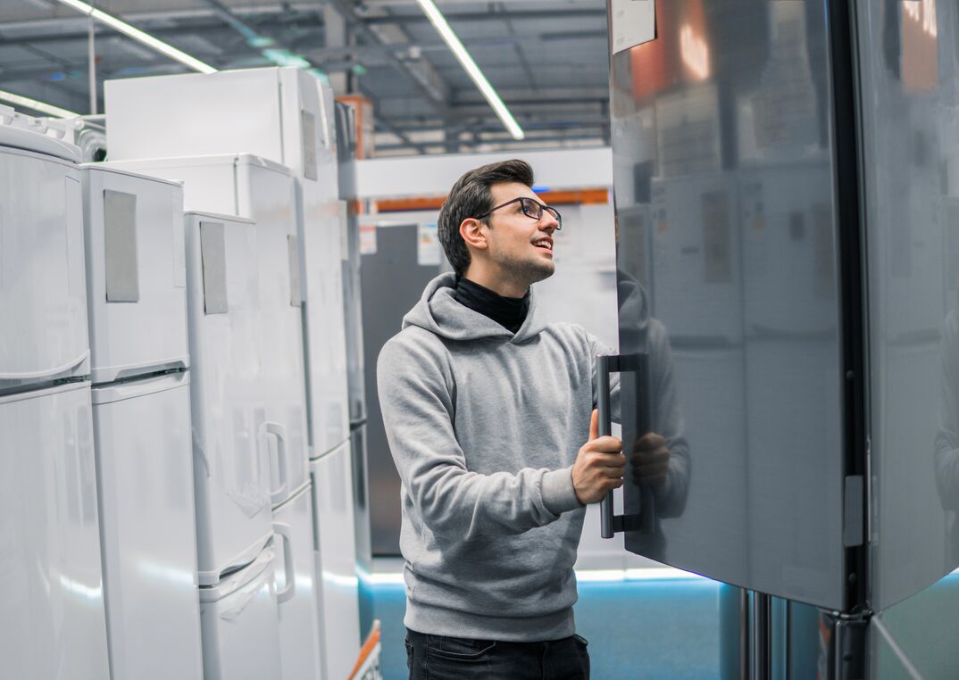 customer choosing large fridges in domestic appliances section