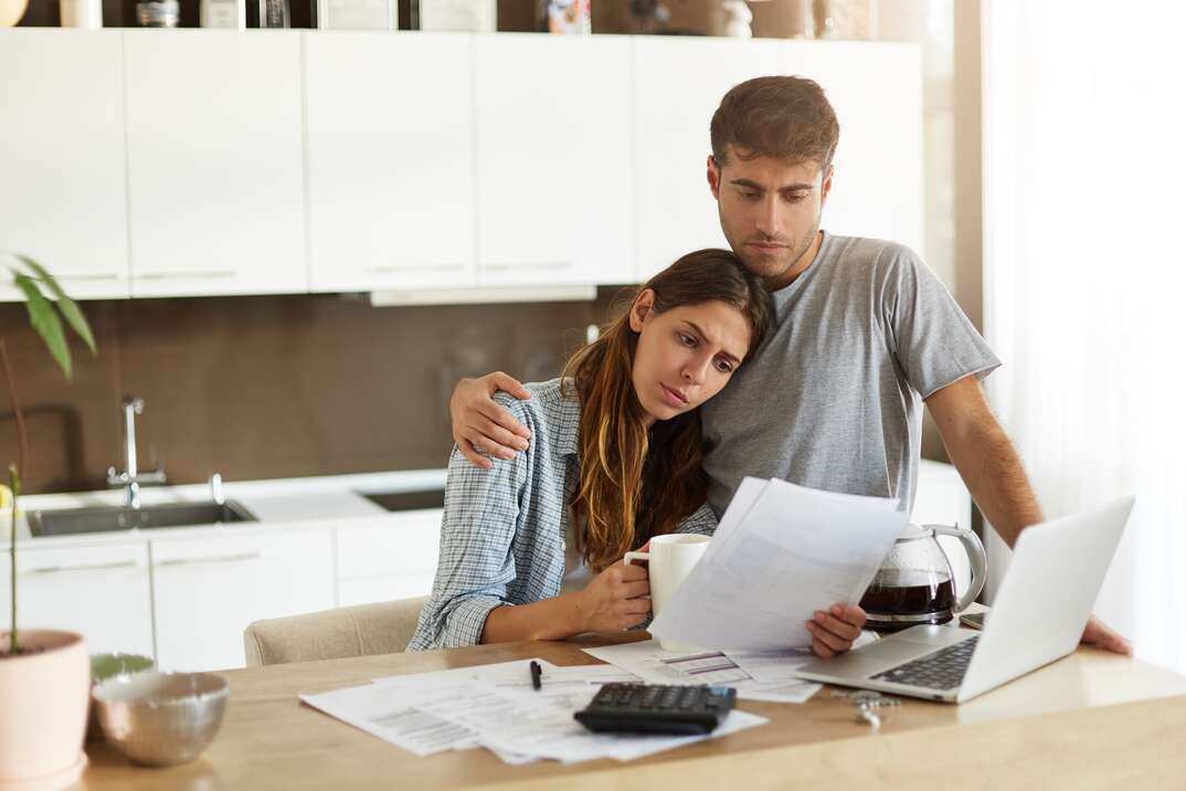 Negative human emotions. Financial problems. Portrait of unhappy young couple having looking worried while reading notification informing them about eviction from appartment because of unpaid bills