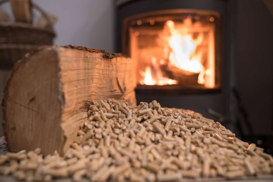 Wood stove heating with in foreground wood pellets
