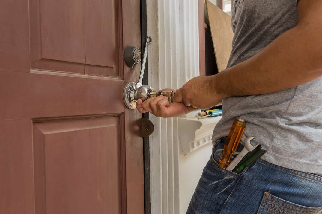 locksmith try to open the wood door by many tools
