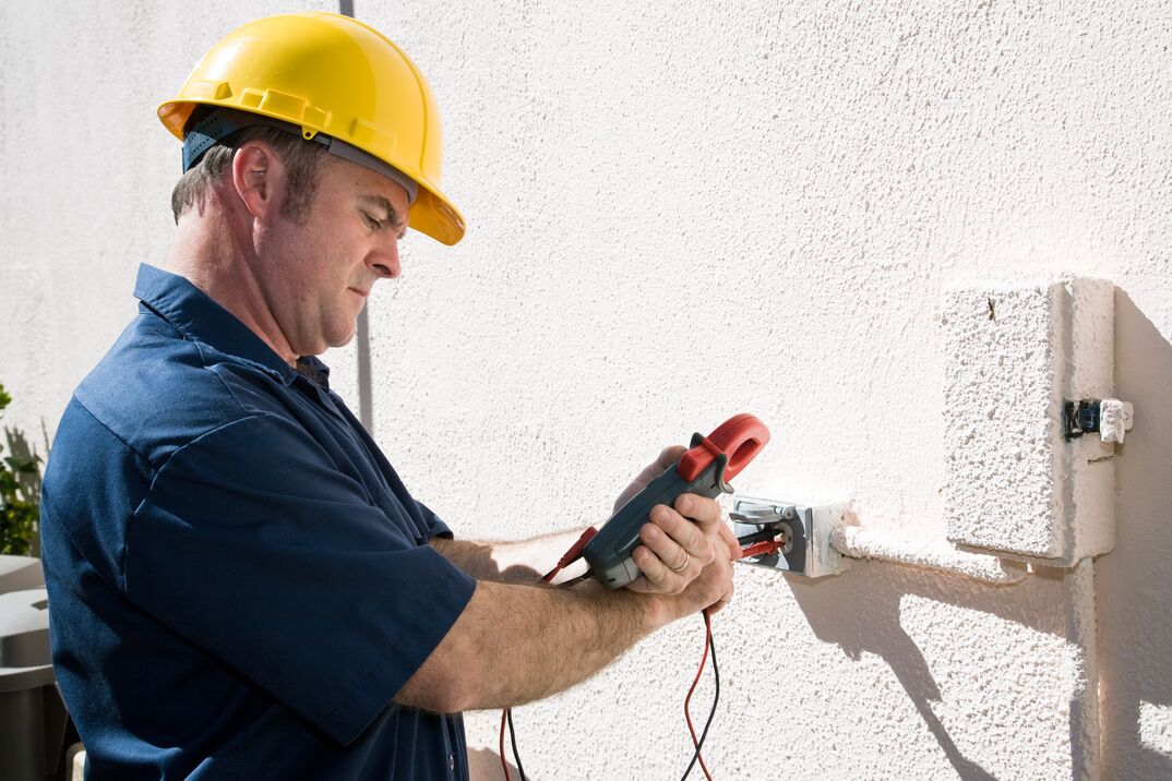 electrician checking outdoor meter