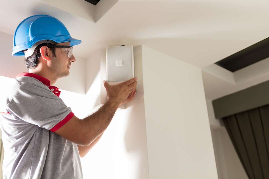 Worker installing speaker