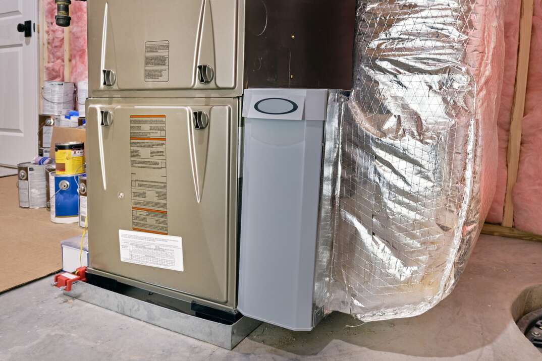High efficiency furnace with air filter container