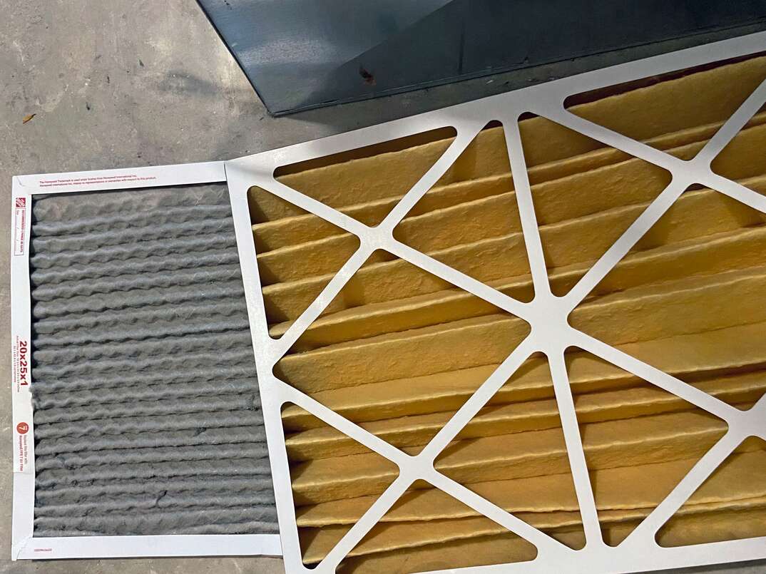 Clean furnace filter and dirty filter in a side by side comparison