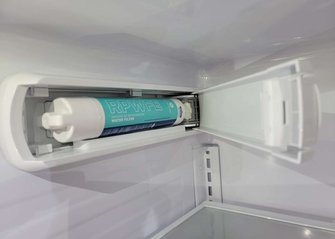 Open panel in refrigerator to change ice maker water filter