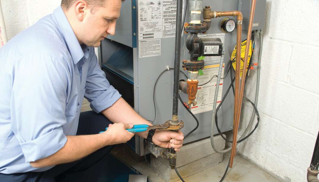 technician fixing furnace