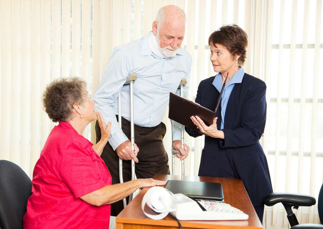 Injured man and his wife meet with a personal injury lawyer.