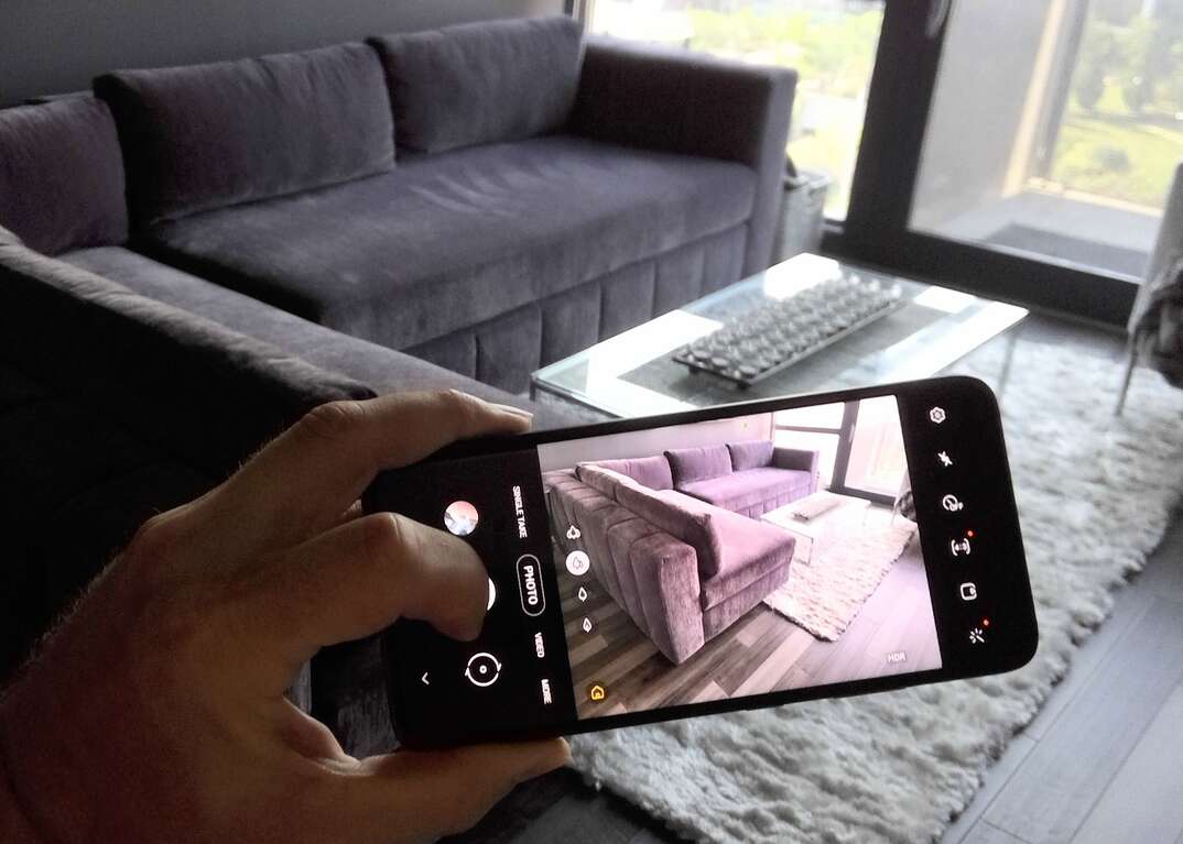 taking picture of living room couch with smartphone
