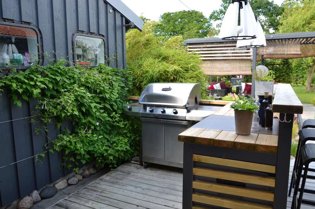 Outdoor kitchen with a stainless gas grill