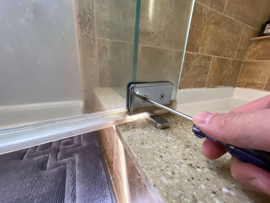 handyman installing glass shower doors