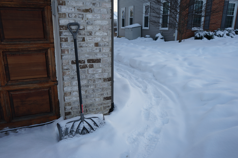 snow covered walkway and shovel