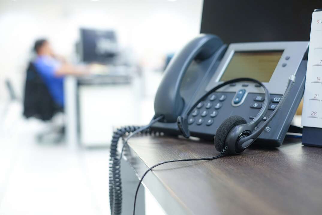 close up soft focus on telephone devices at office desk for customer service support concept,call centre operation room