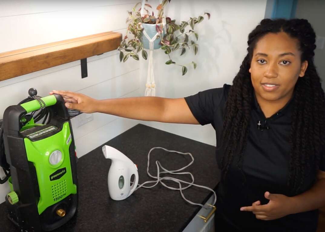 A woman points to two consumer household products to demonstrate how to determine if a particular item has been recalled by federal safety authorities.