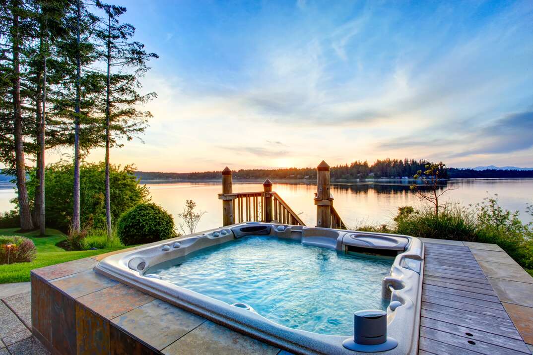 Awesome water view with hot tub in summer evening 