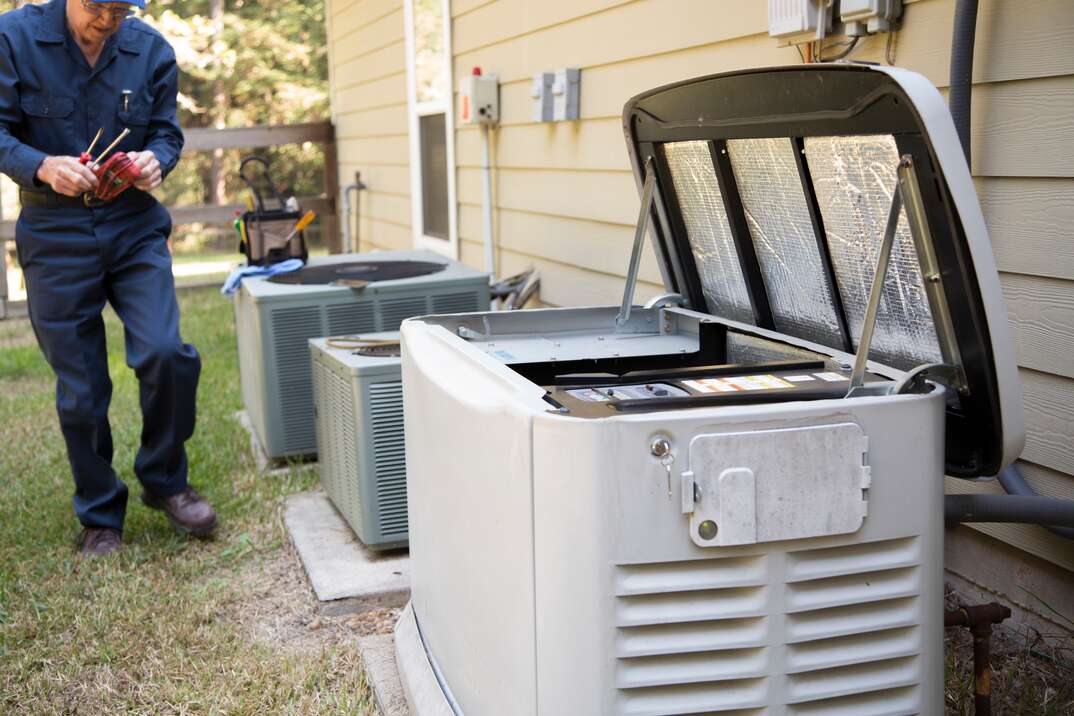 Senior Adult air conditioner Technician/Electrician  services outdoor AC unit and the Gas Generator.