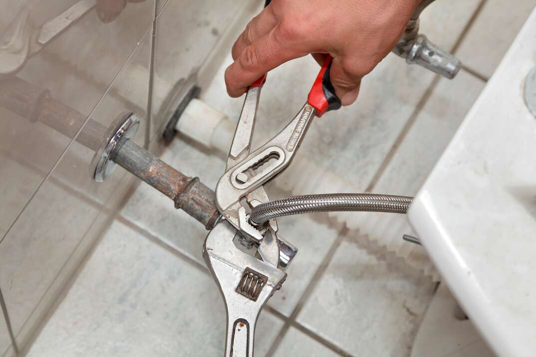 plumber fixing under sink