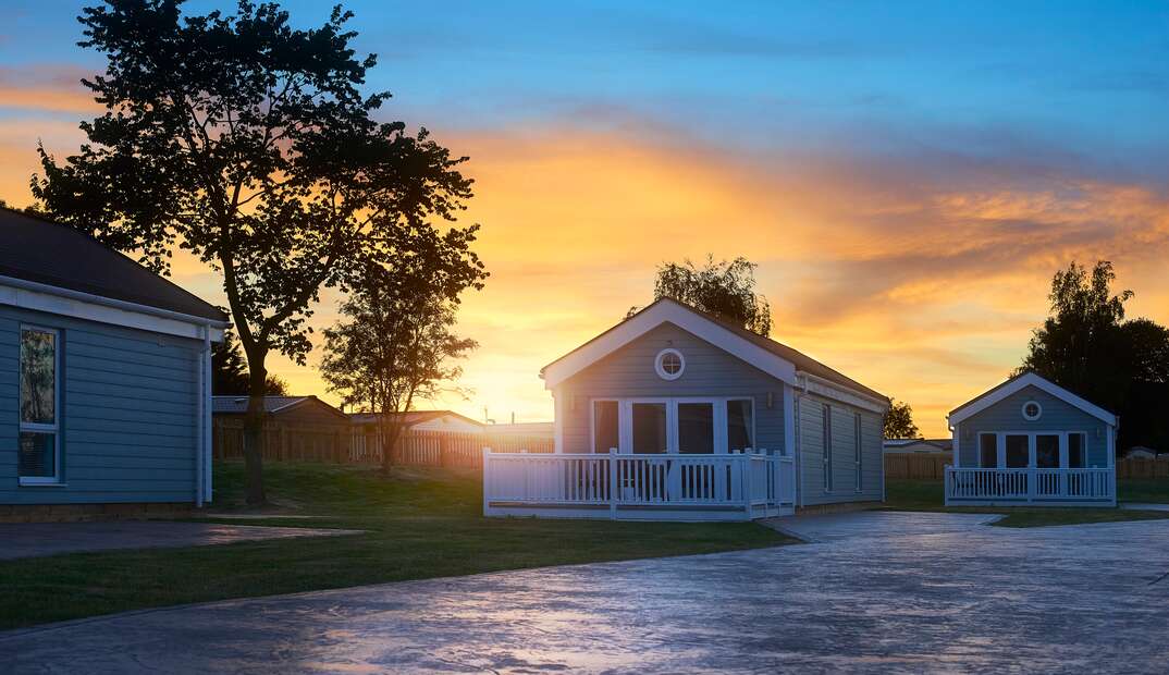 three manufactured homes sitting side by side during sunset