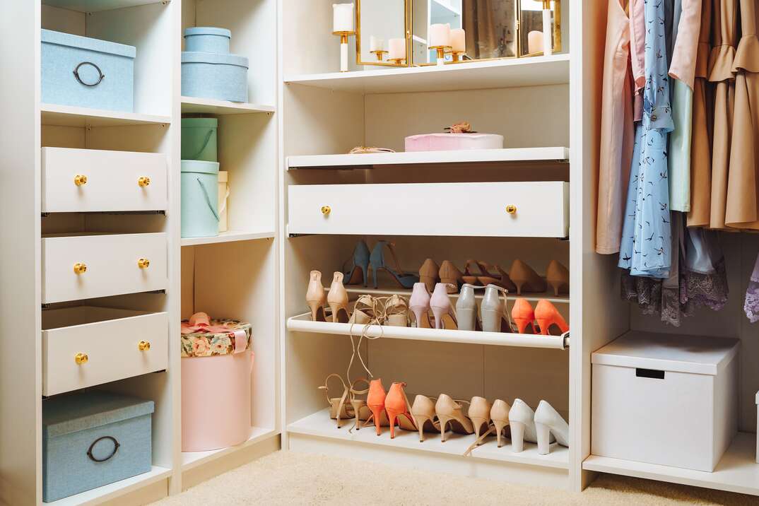 Large wardrobe with stylish women s clothing, accessories and boxes. Organization of storage space and fashion concept, shoes