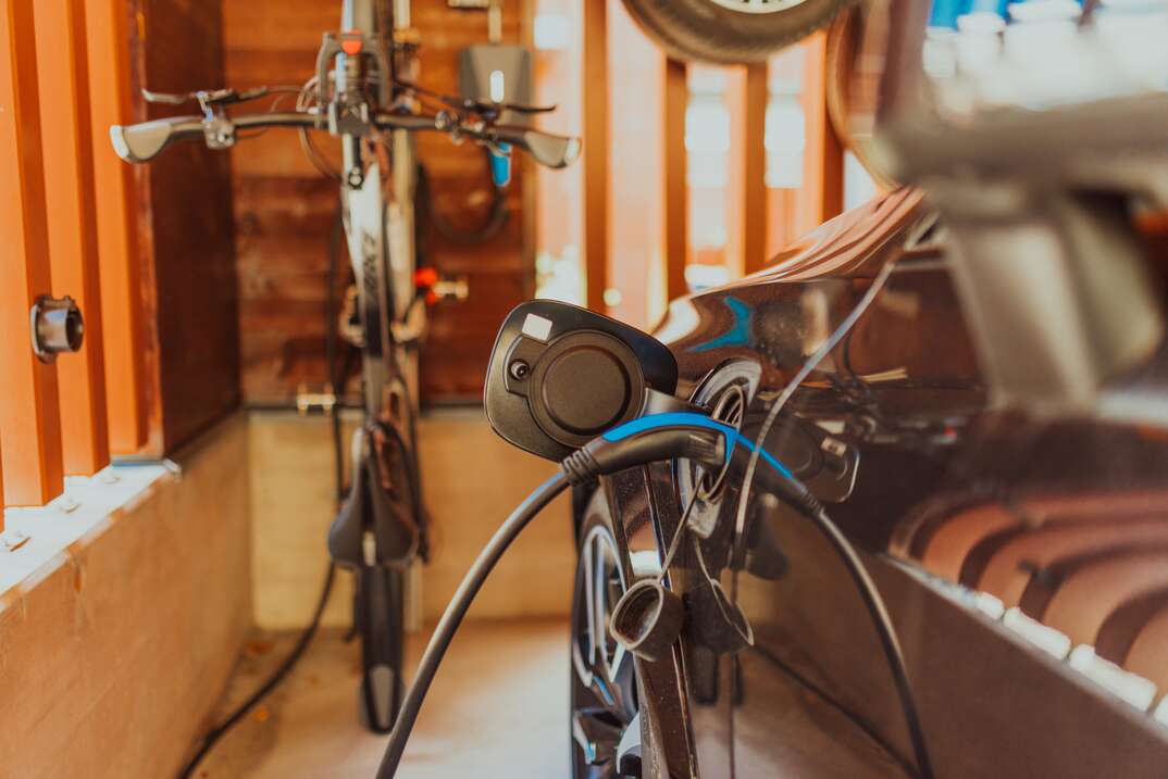 Charging a electric car in the garage of a modern house. High quality photo