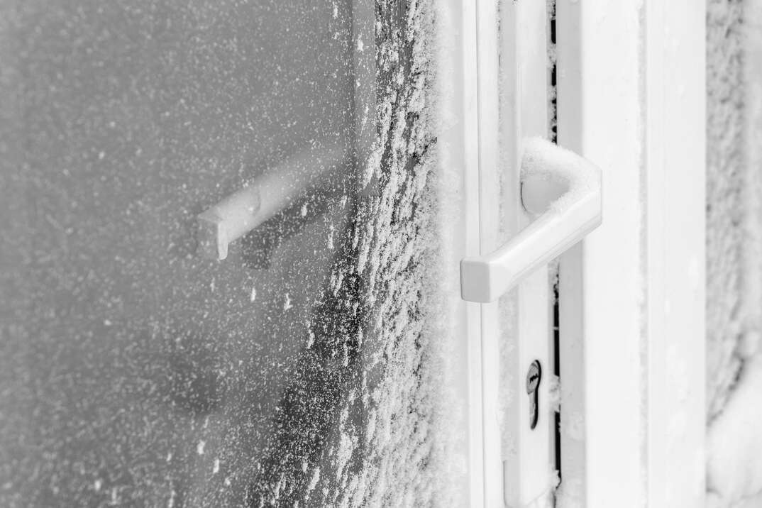 The storm door is covered with snow