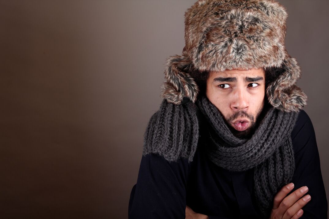 freezing cold man wearing scarf and fur hat