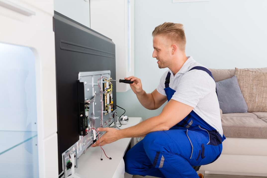 Electrician Repairing Television