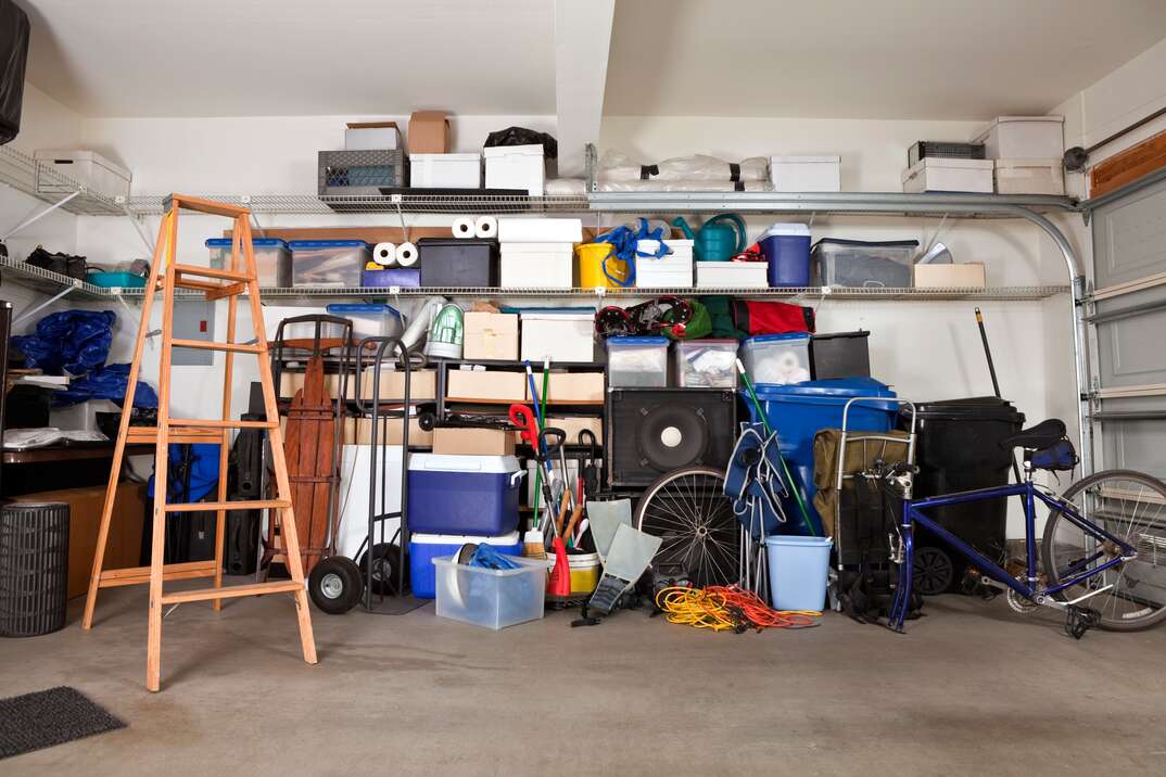 Suburban garage mess.  Boxes, tools and toys in disarray.
