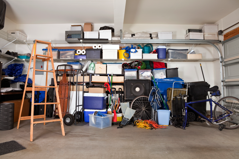 Suburban garage mess.  Boxes, tools and toys in disarray.
