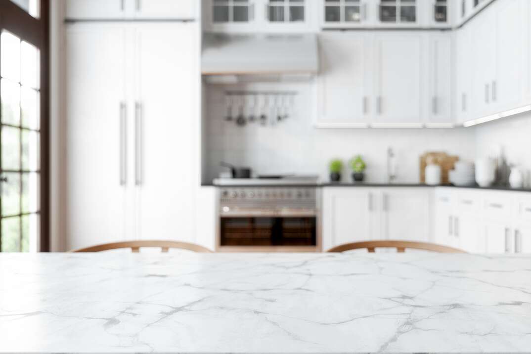 Empty Marble Dining Table With Wooden Chairs And Defocused Kitchen Background 