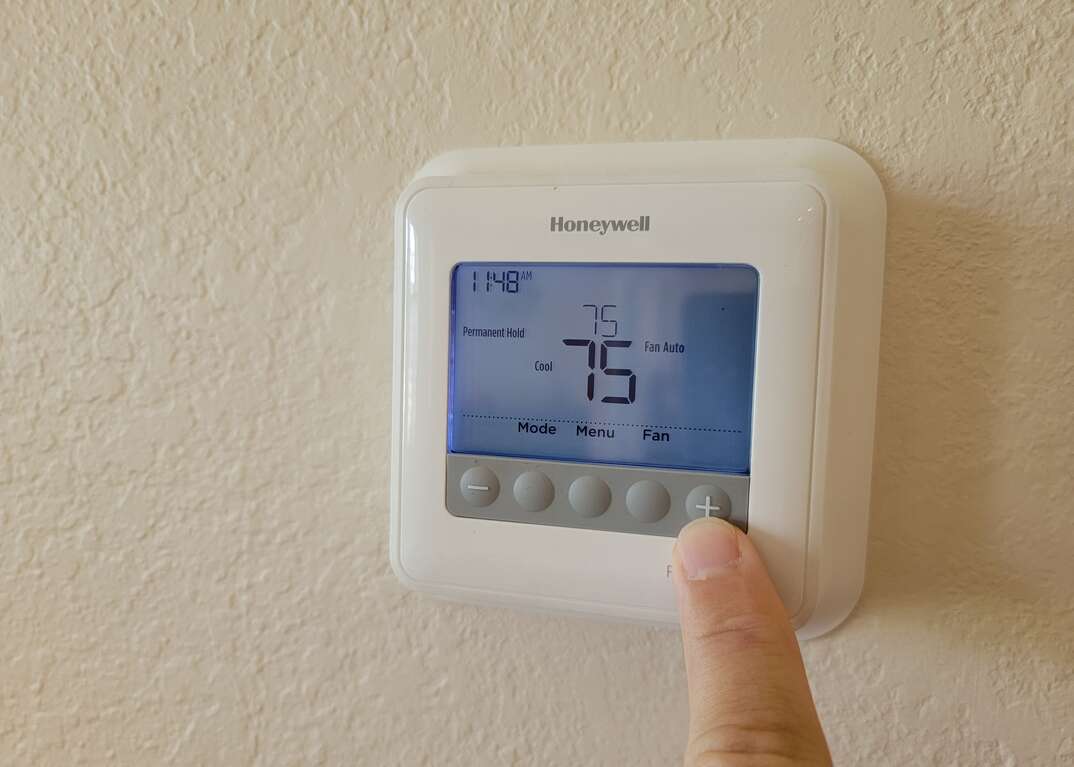 Pushing button on Honeywell thermostat