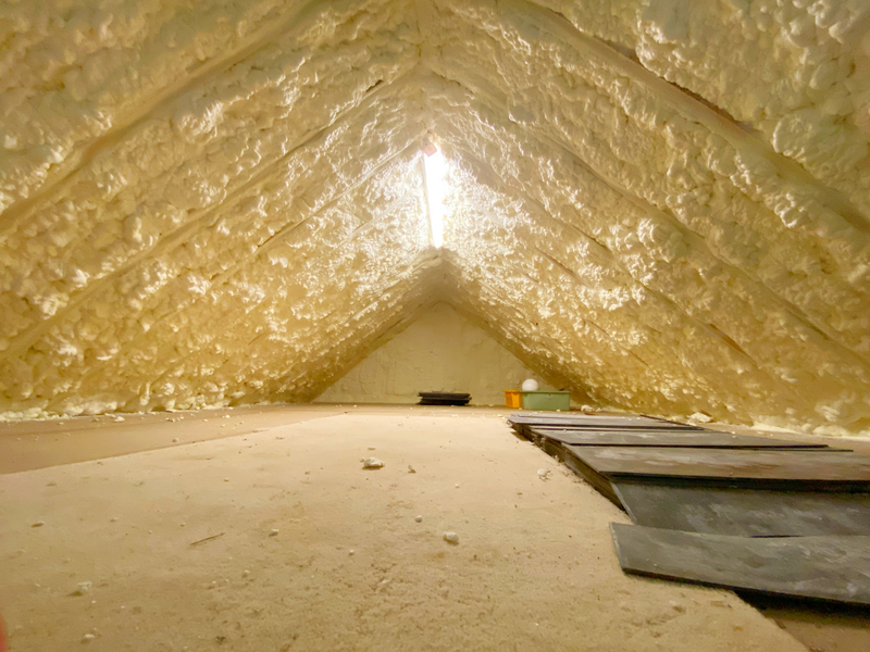 Attic pumped with spray foam insulation to reduce heat loss