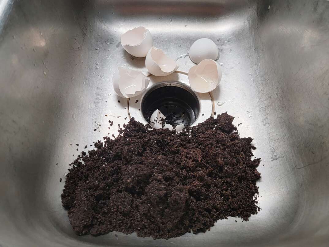 putting coffee grounds and egg shells down sink drain