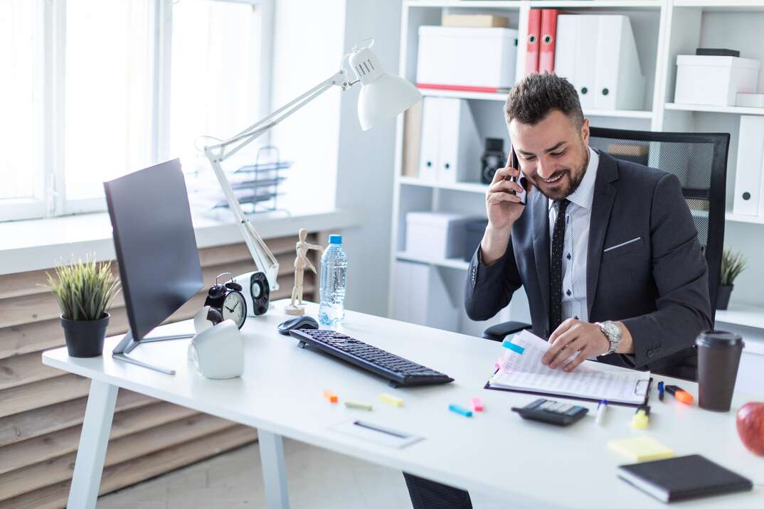 A bearded man with a business suit is working in a bright office. photo with depth of field.