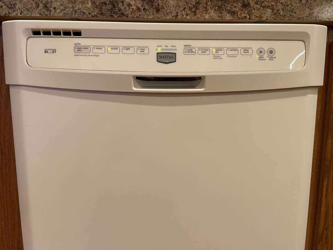 white dishwasher mounted under countertop