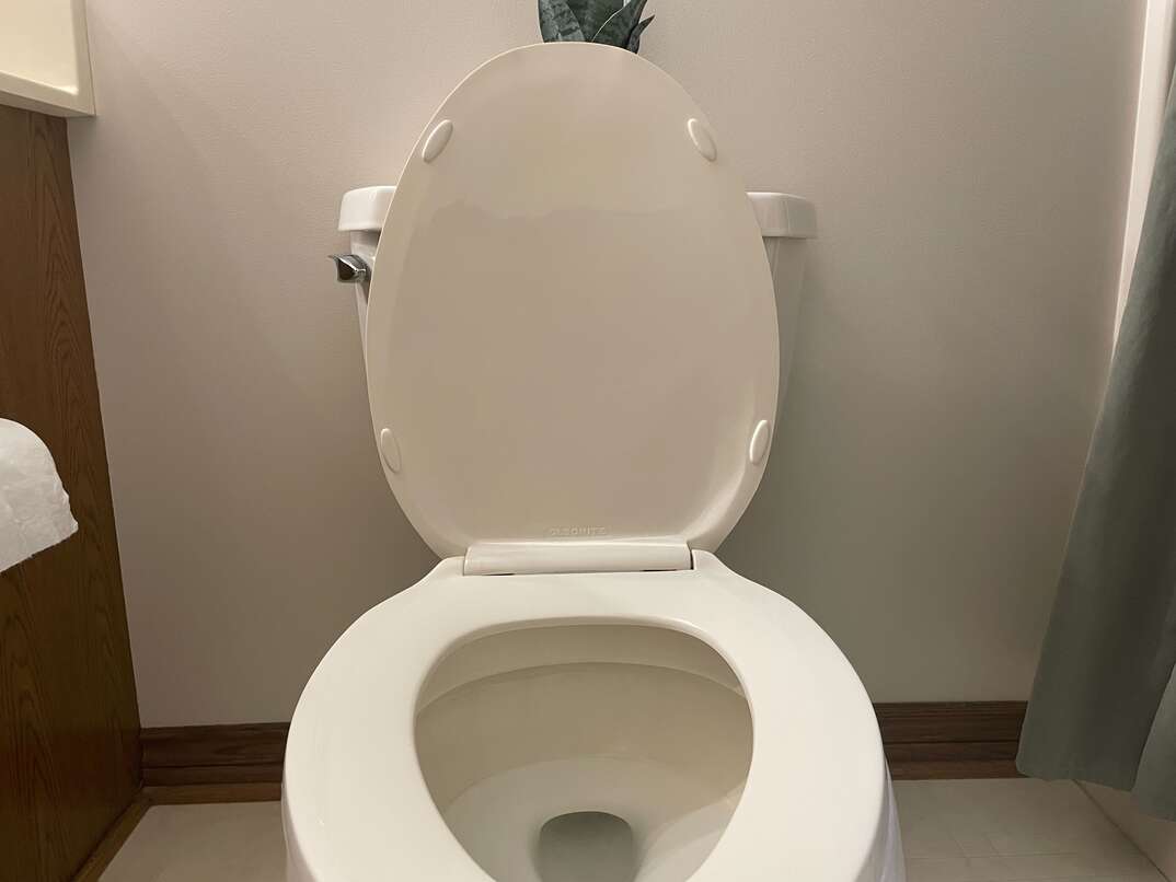 white open toilet in bathroom