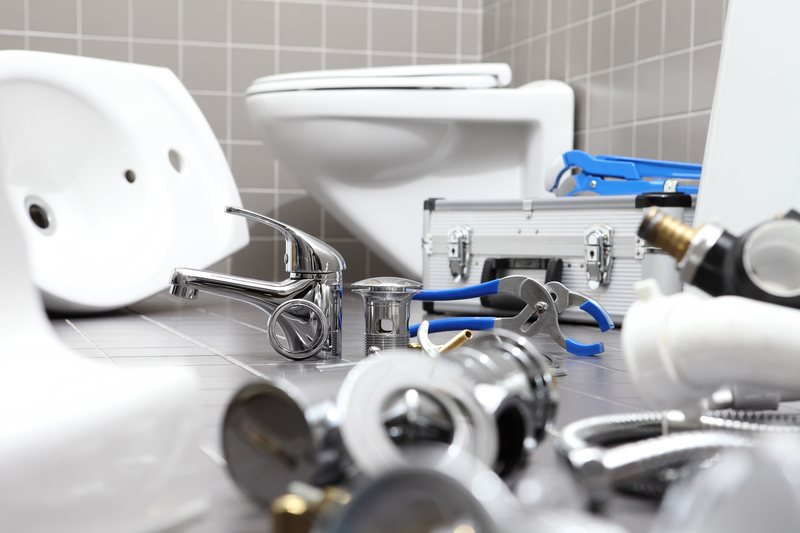 plumber tools and equipment in a bathroom, plumbing repair service, assemble and install concept