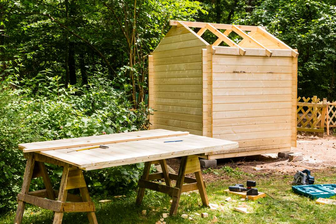 a backyard job site with construction of a shed taking place