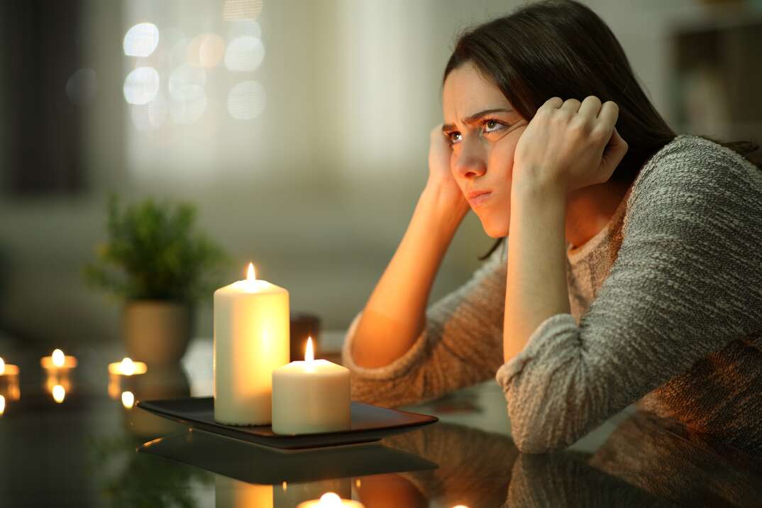 Woman sitting in dark during power outage