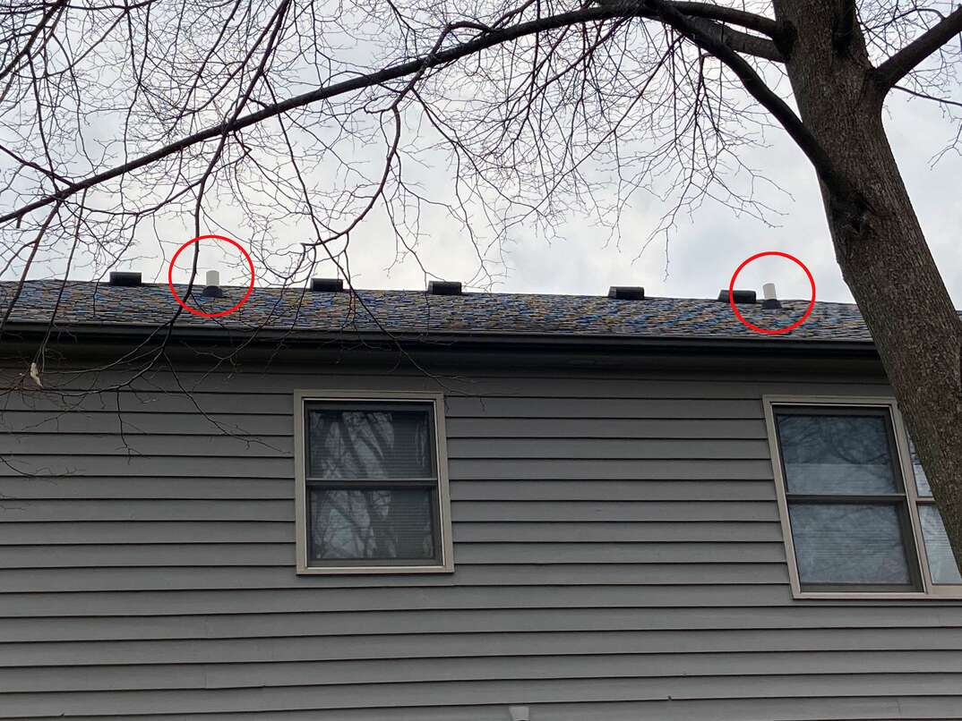 two highlighted exterior plumbing ehxaust vents