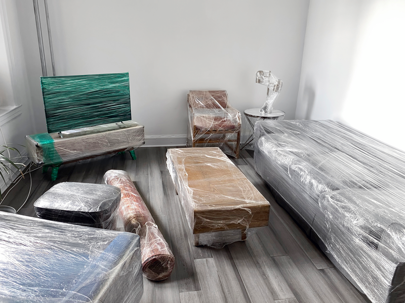 Moving concept with furnitures wrapped up with plastic