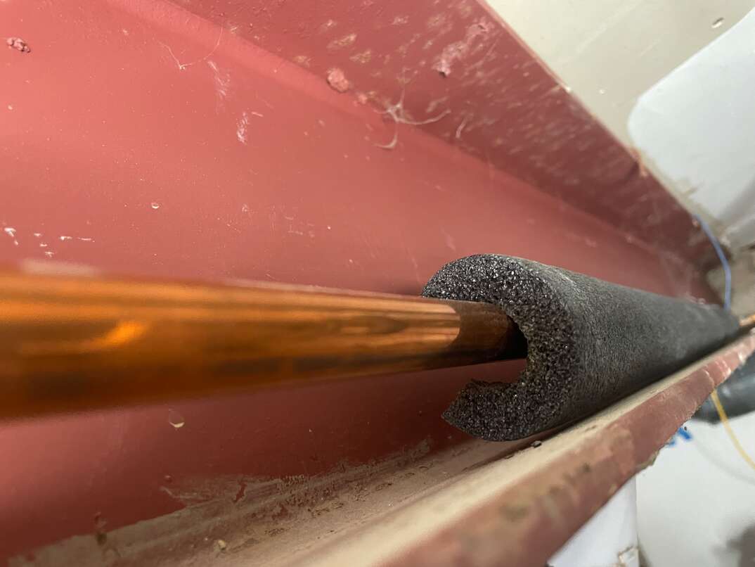 Copper pipe insulated with black foam
