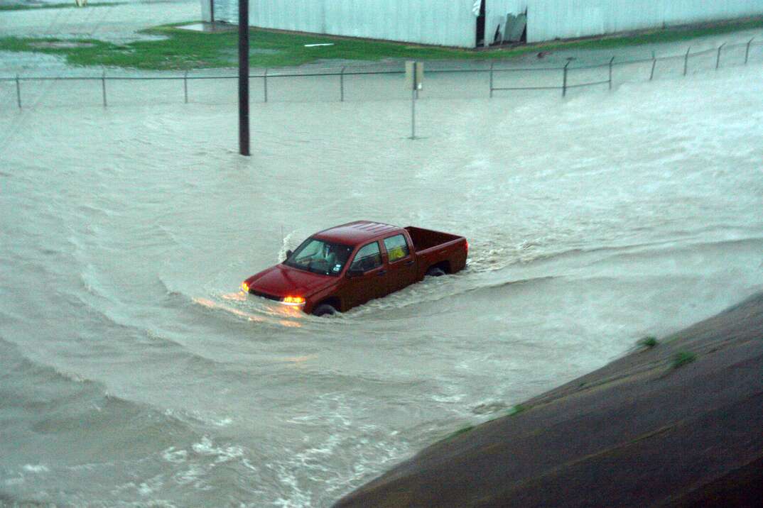 A pickup truck is overtaken by flood waters, pickup truck, truck, pickup, flood, floodwaters, flood waters, storm, storm damage, damage, disaster, natural disaster