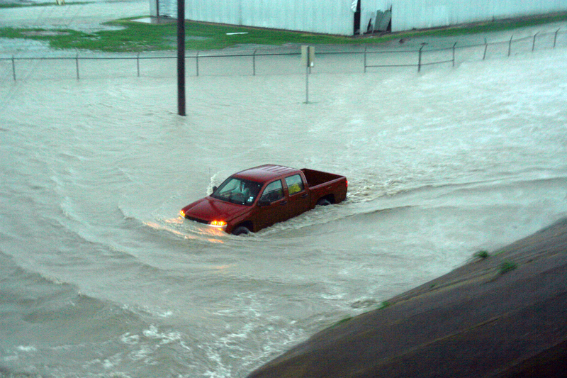A pickup truck is overtaken by flood waters, pickup truck, truck, pickup, flood, floodwaters, flood waters, storm, storm damage, damage, disaster, natural disaster